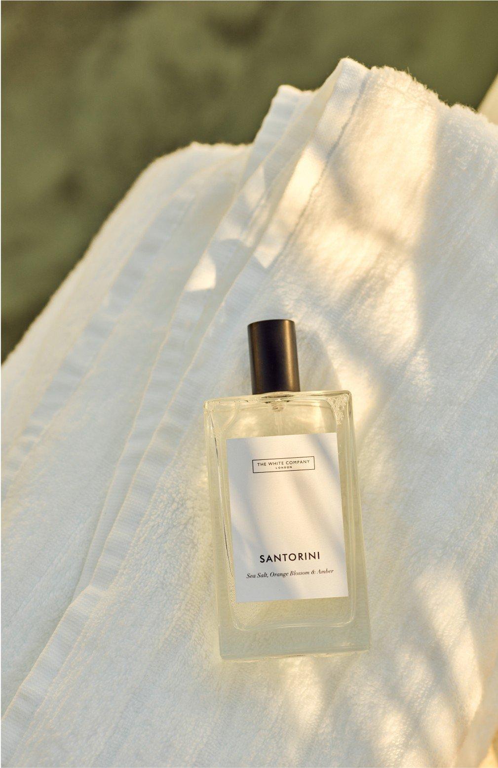 a bottle of perfume sitting on top of a white towel